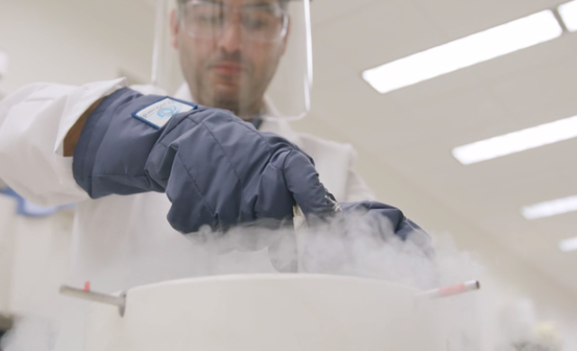 scientist pulling something out of a chiller