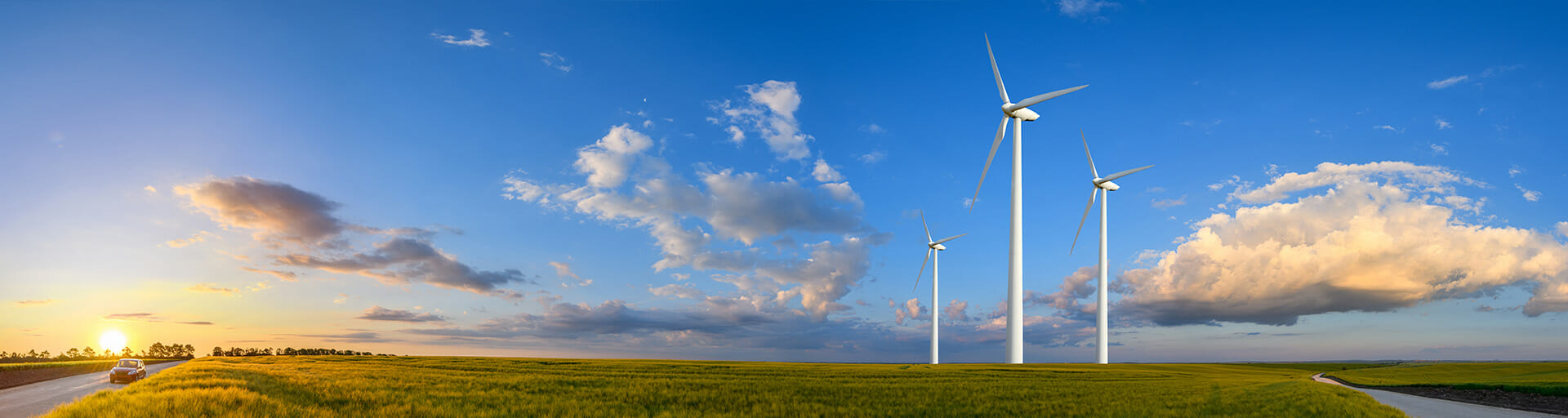
		Three wind turbines in a field		